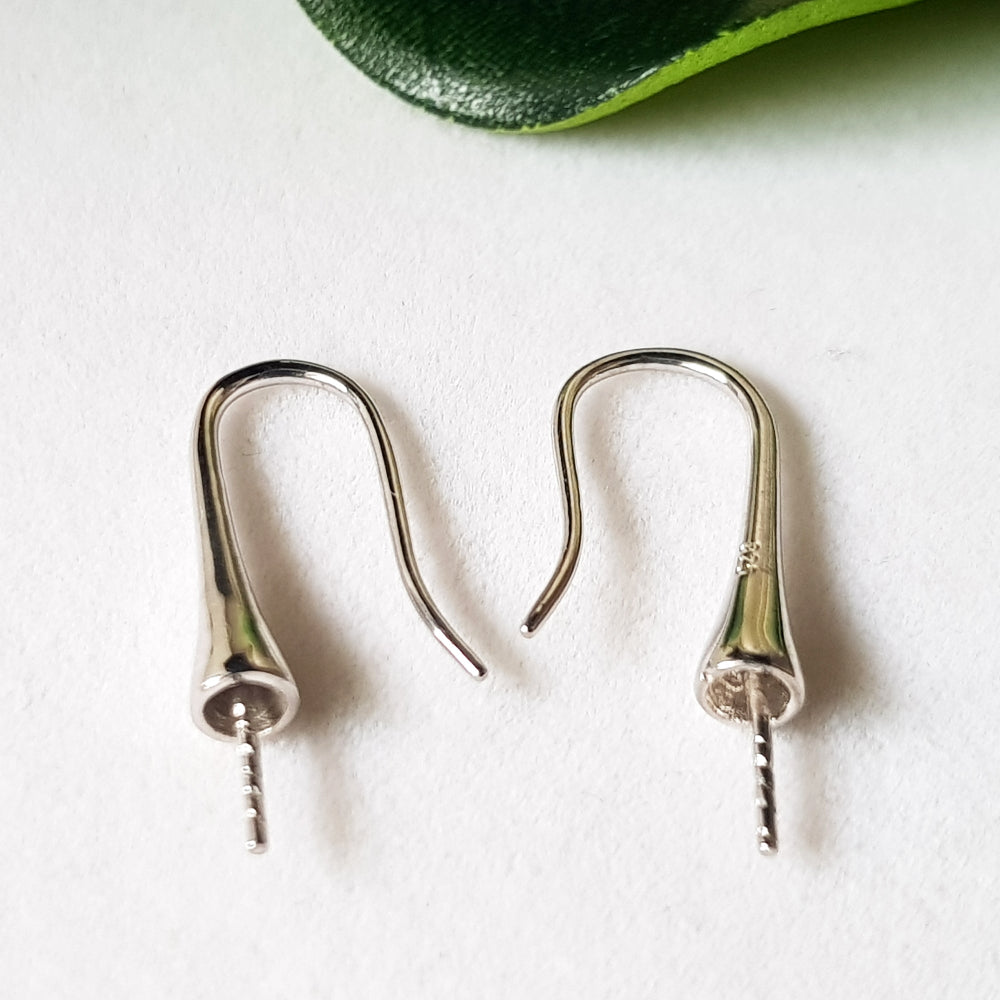A pair of sterling hooks on a white background.