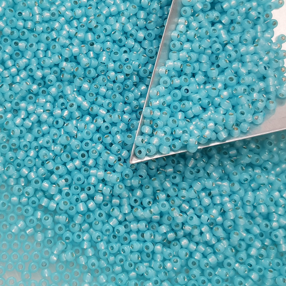 11/0 Toho seed beads in milky aqua silver-line with a triangle scoop.