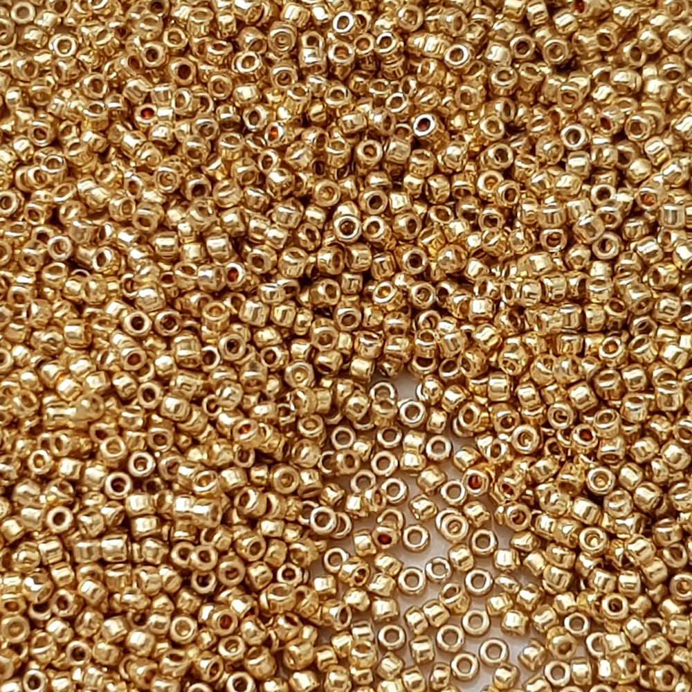 Toho 15/0 starlight gold galvanized permanent finish TR-pf557 close up.