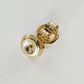 Yellow Gold Earring backs on white background.