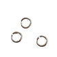Three silver jump rings open on a white background