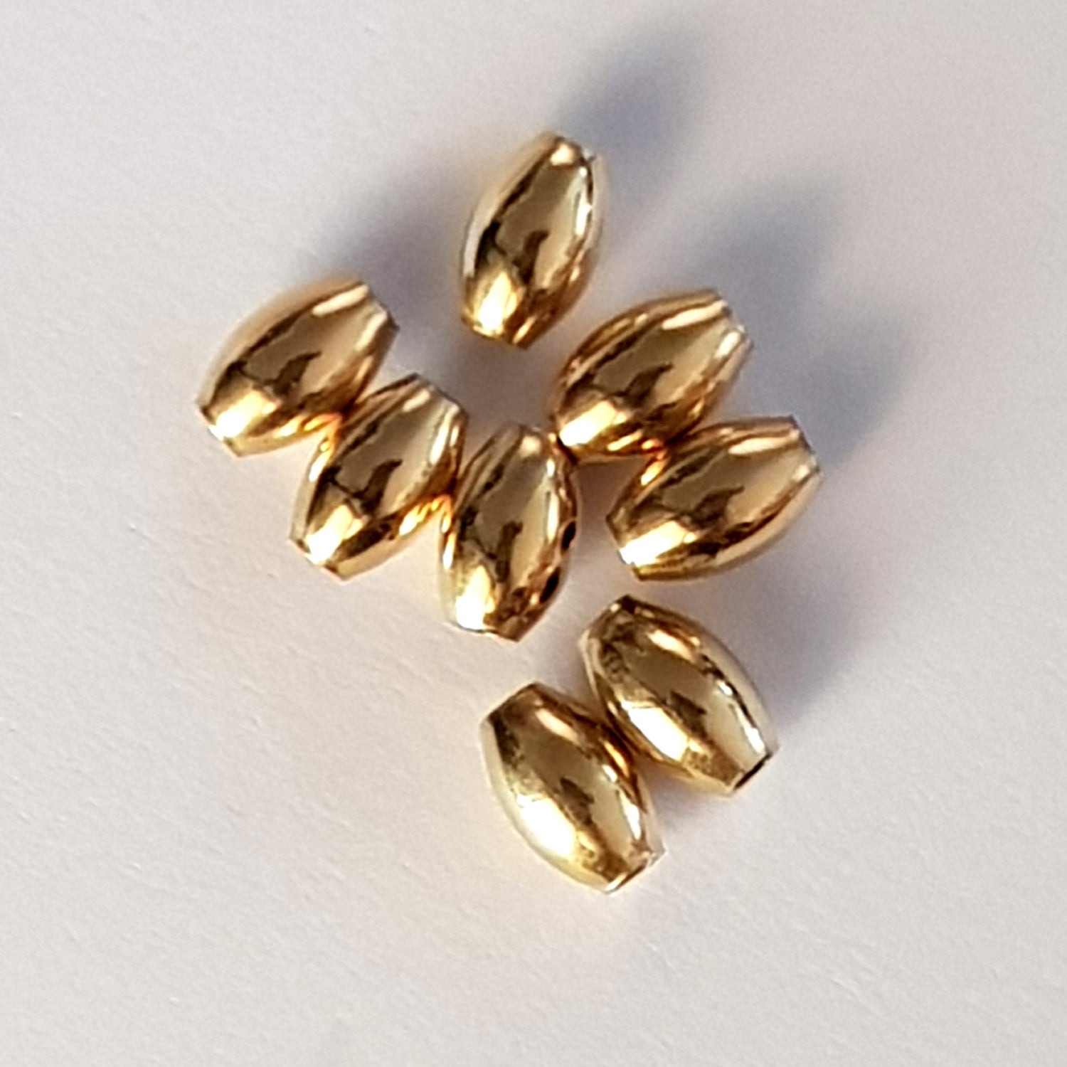 Gold beads on a white background