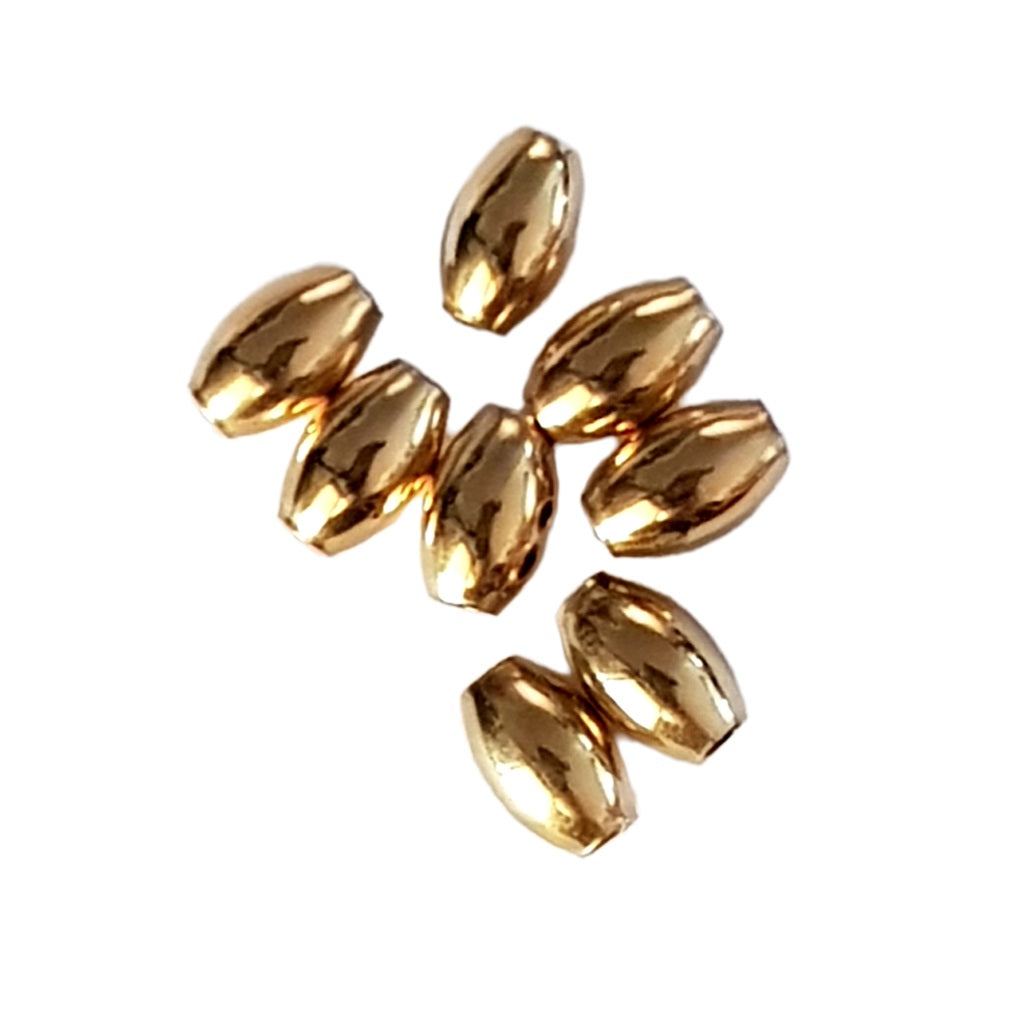 Gold beads on a white background