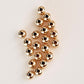 Gold beads on a light beige background