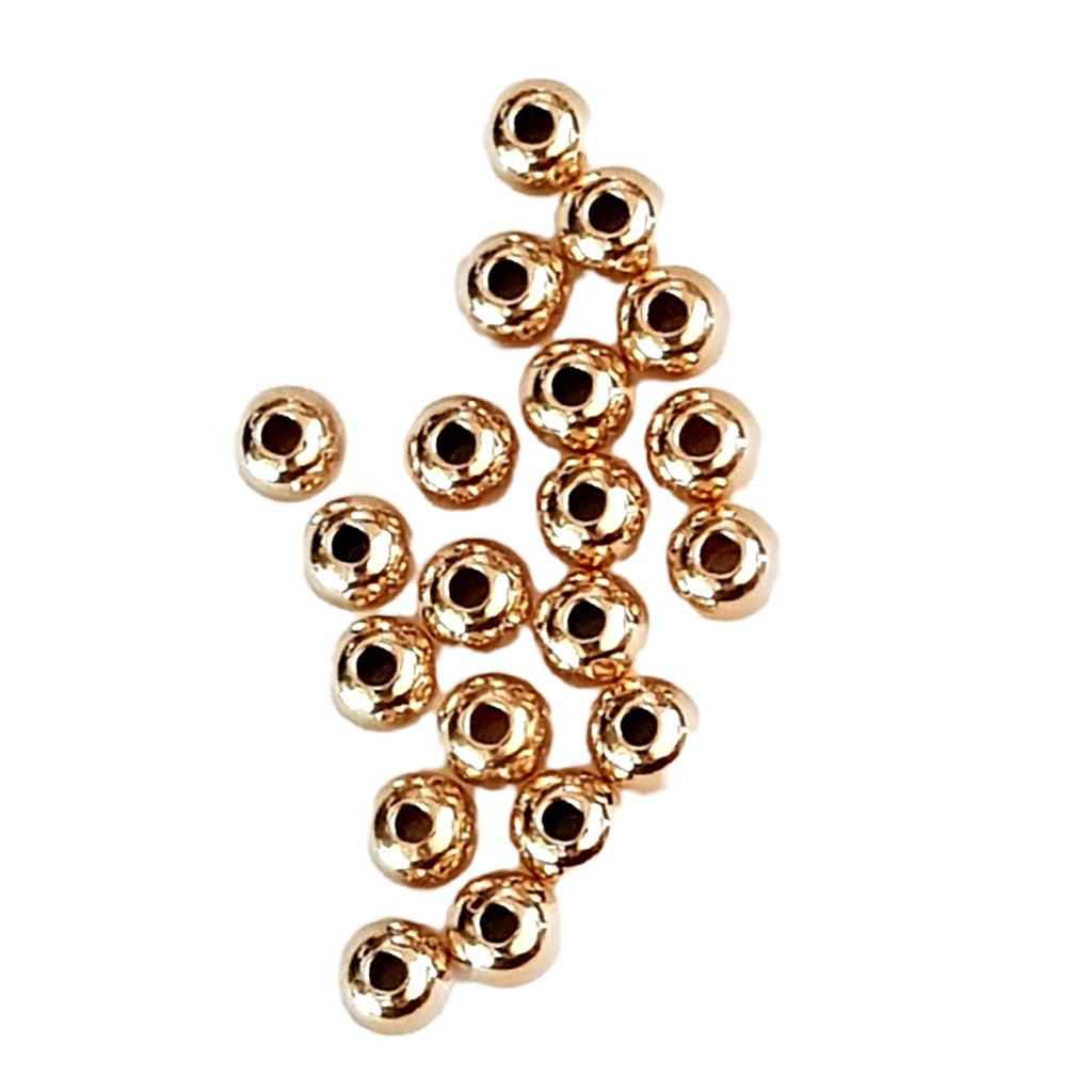 Gold beads on a white background