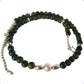 Necklace with green beads and a pearl on a white background