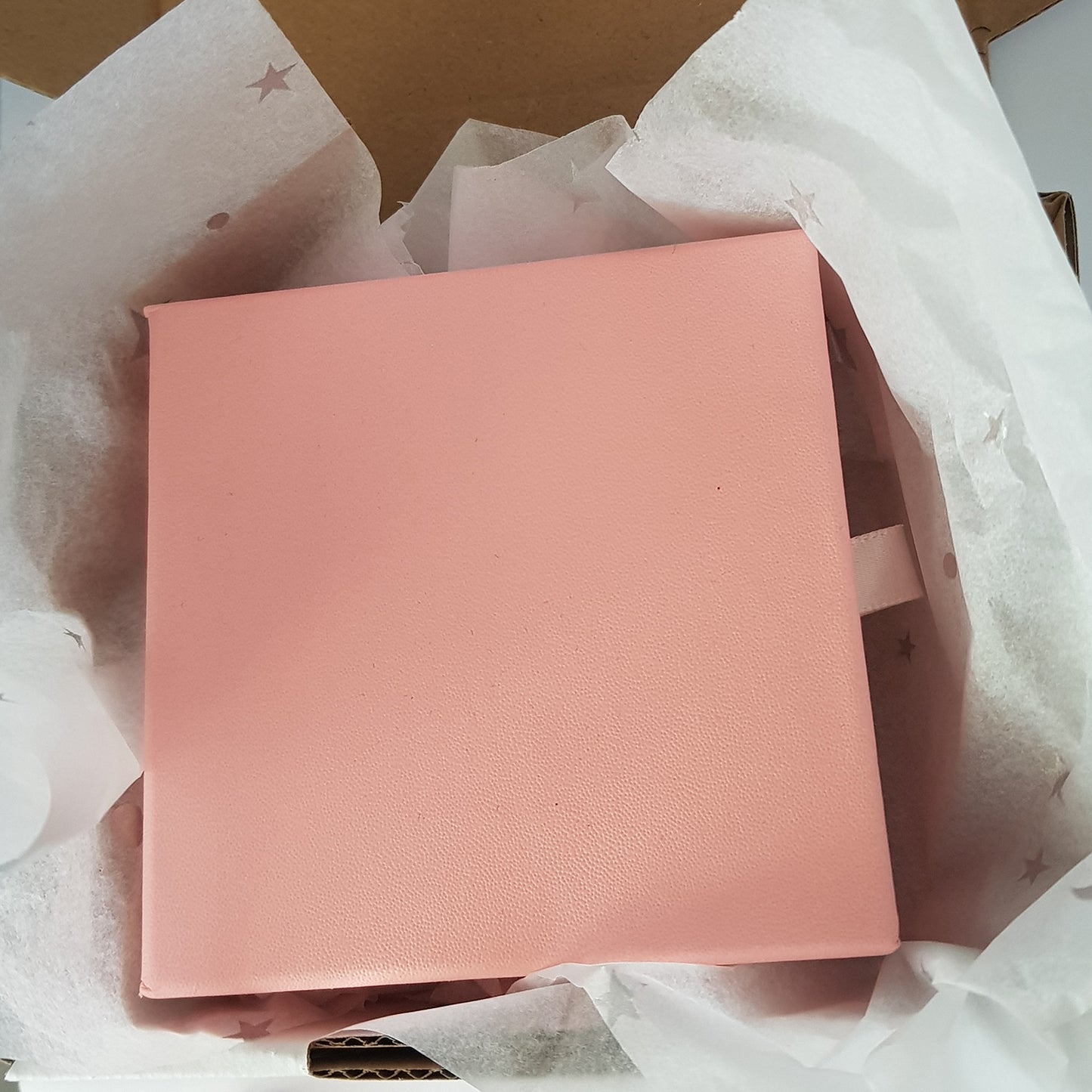 Packaged in a Pink box with white tissue paper