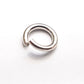 An open sterling silver jump ring on a white background.
