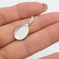 Oval Pendant Bezel Setting on a hand. white background