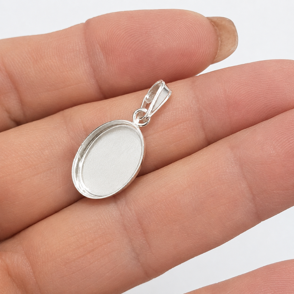 Oval Pendant Bezel Setting on a hand. white background
