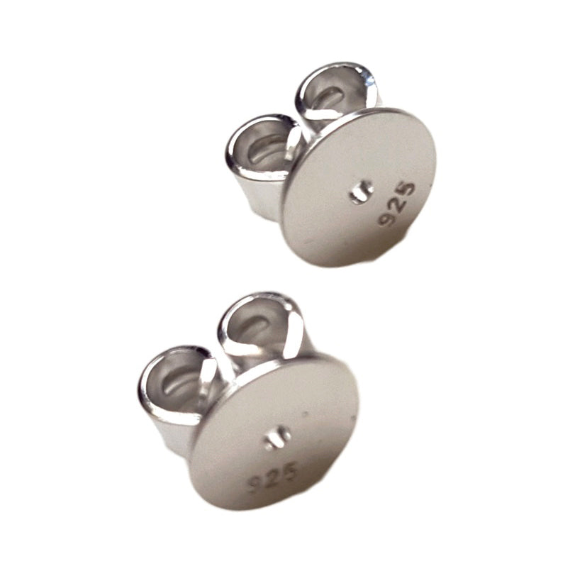 Pair of sterling silver 925 disc earring backs white background.