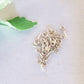 A bunch on soldered eye pins on a white background
