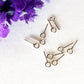  soldered closed eye-pins made of sterling silver, on a white background purple flower top corner.