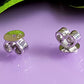 White Gold Disc Butterfly Earring Backs on a pink background.