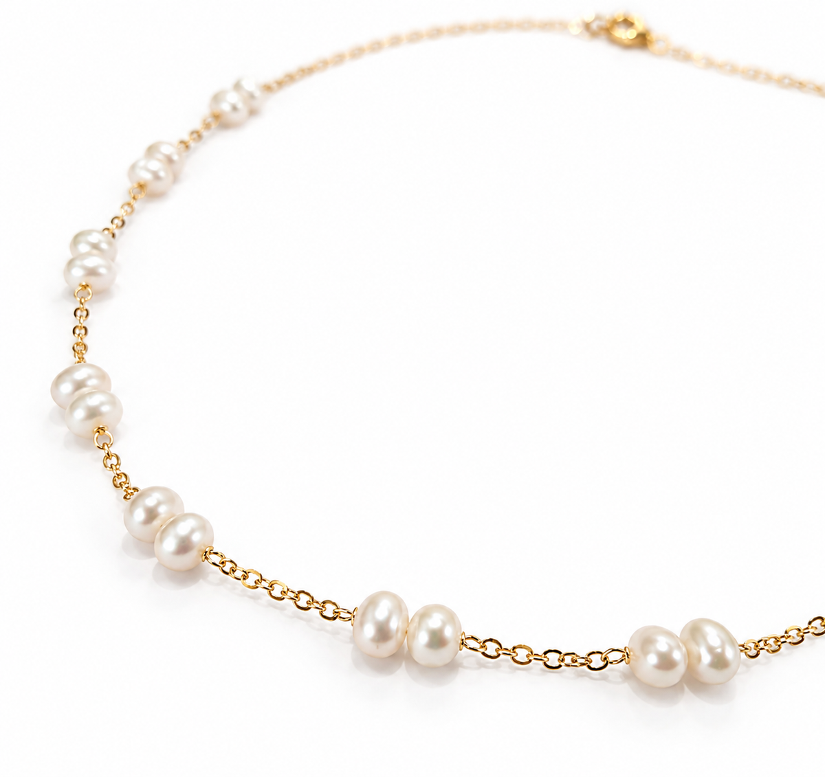 Close-up of freshwater pearls wire-wrapped on gold filled cable chain, showing natural pearl lustre and gold link detail