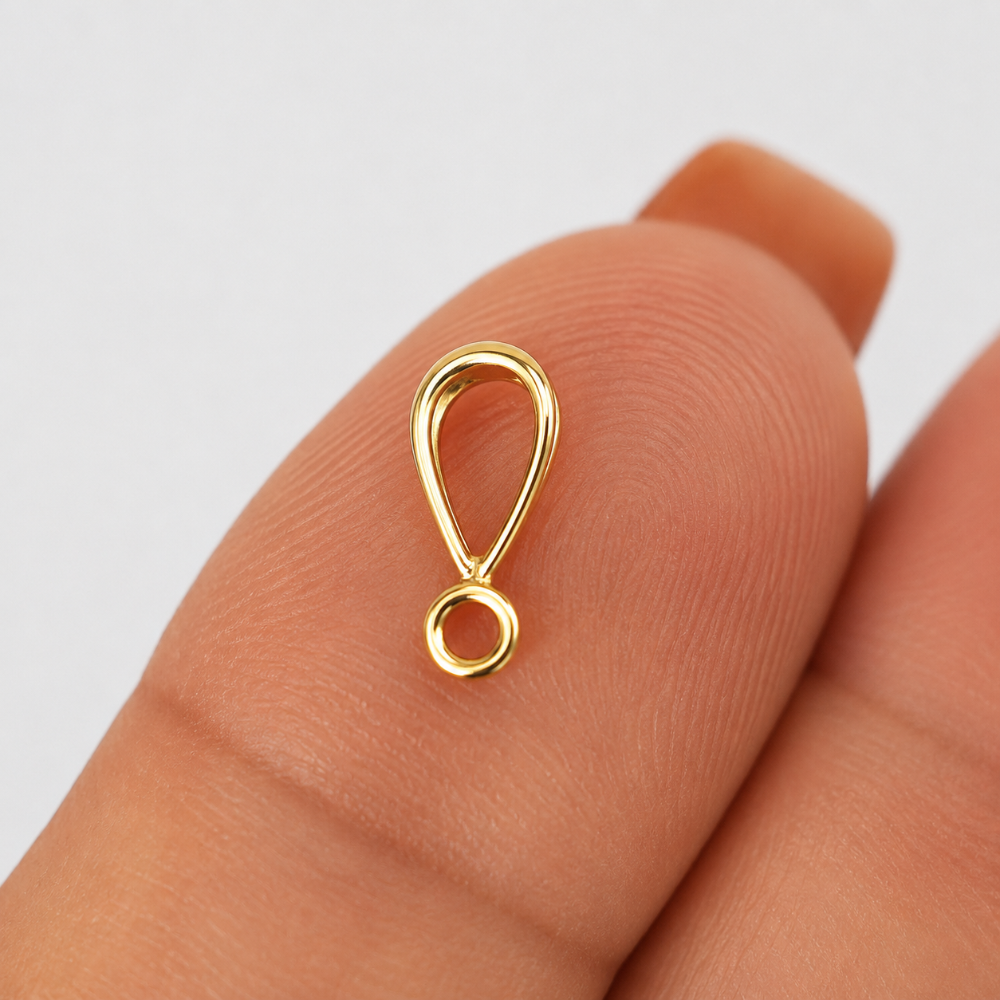 Side view of Gold Filled Pendant Bail on a finger with white background
