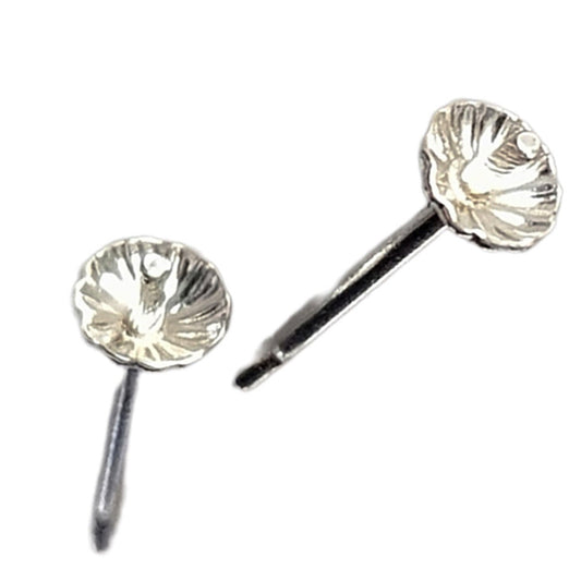 Pair of silver shell-shaped earrings on a white background