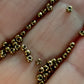 close up antique bronze beads on a hand.