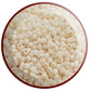 A close-up view of egg shell frosted opaque pastel round Toho seed in beads. circle with white bakcground.