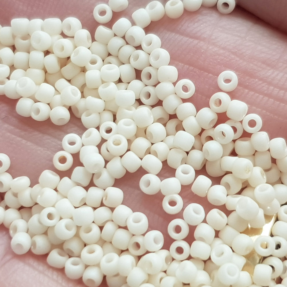Close up egg shell beads on a hand.