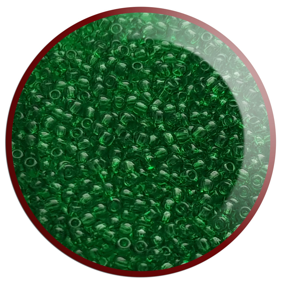 A close-up view of grass green transparent round Toho seed beads. 11/0 TR-7B white background.