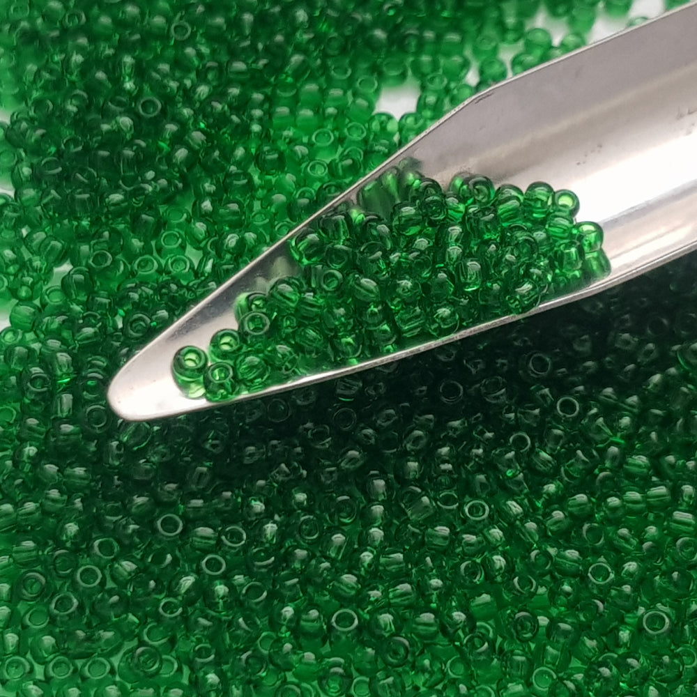 11/0 toho seed beads in grass green transparent with a beading scoop.