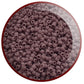 A close-up view of lavender frosted opaque round Toho seed beads.