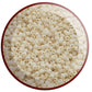 A close-up view of light beige frosted opaque round Toho seed beads. 11/0 circle white background