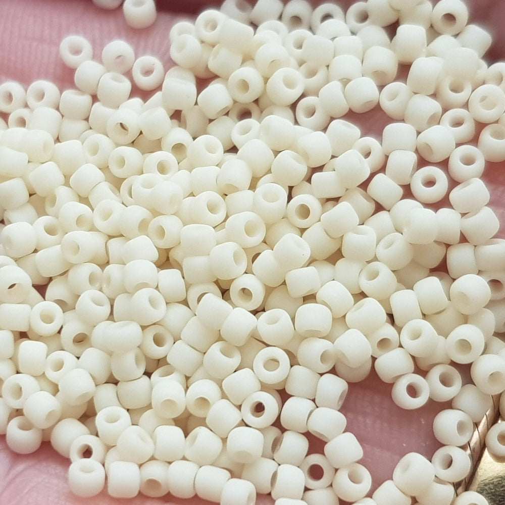 Toho 11/0 TR-51F lt Beige Frosted Opaque Beads on a hand