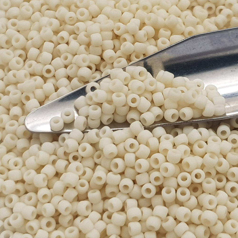 Toho 11/0 TR-51F lt Beige Frosted Opaque Beads with a beading scoop.