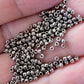 11/0 Toho seed beads on a hand close up of nickel silver beads