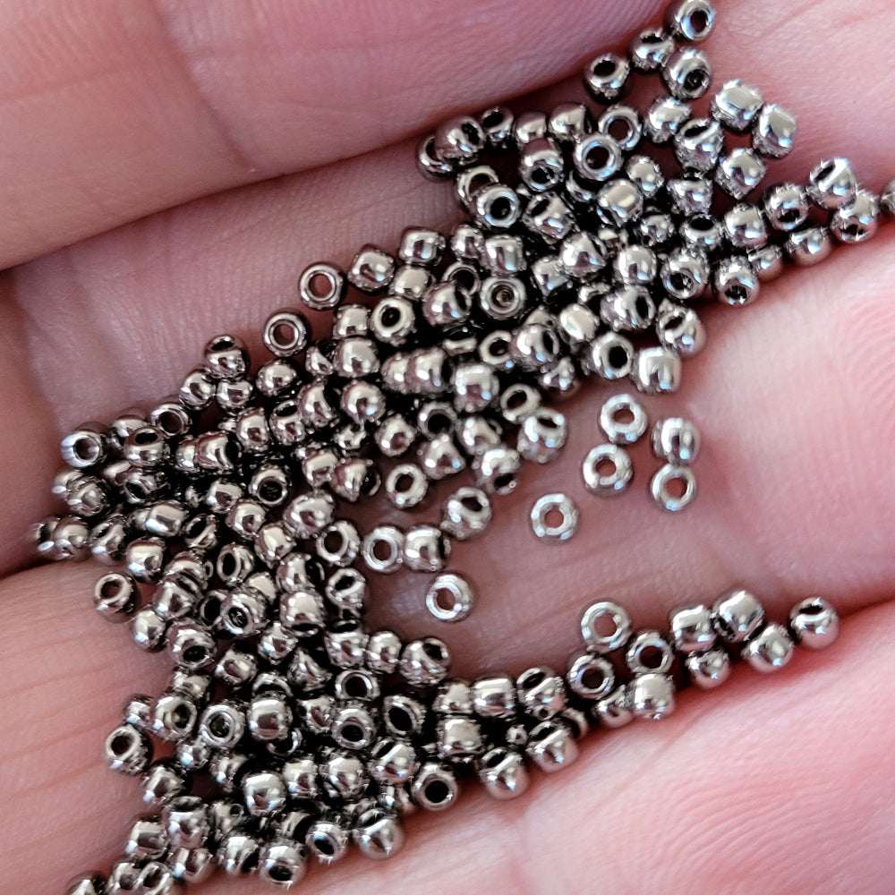 11/0 Toho seed beads on a hand close up of nickel silver beads