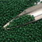 11/0 Toho Seed beads in pine green opaque with a beading scoop.