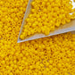 yellow beads with a triangle beading scoop