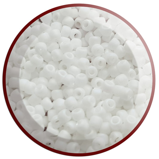 A bowl filled with white frosted opaque pastel round Toho seed  beads 11/0 Close up
