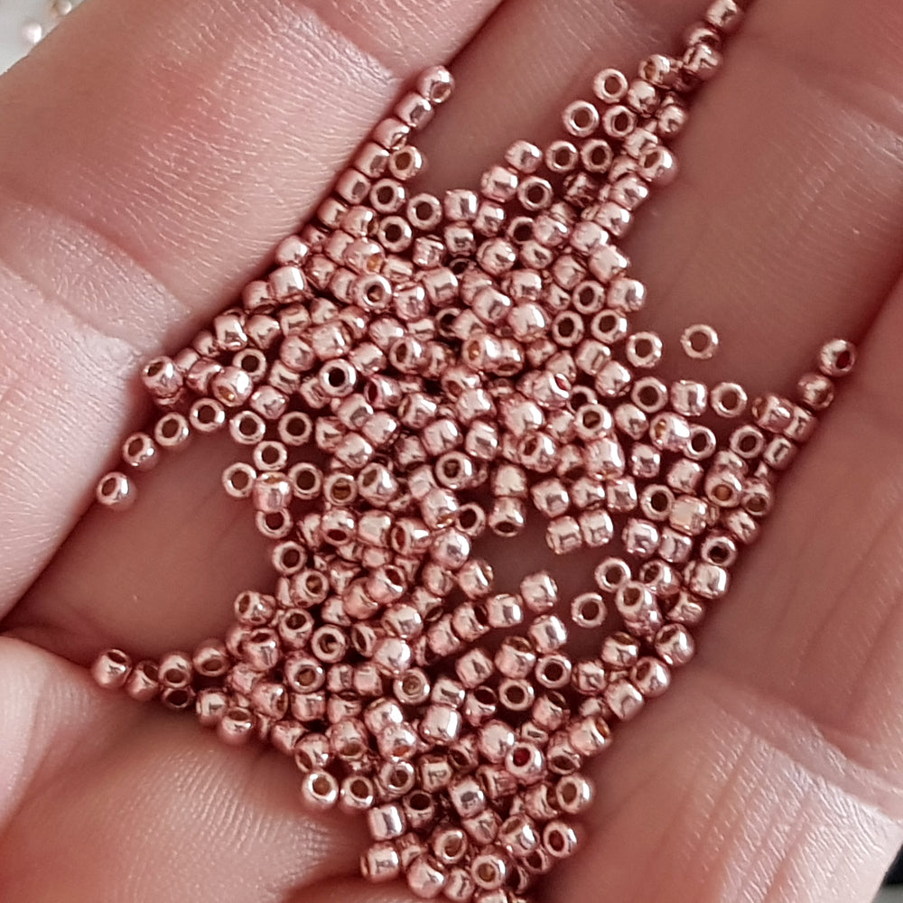 Rose gold beads on a hand
