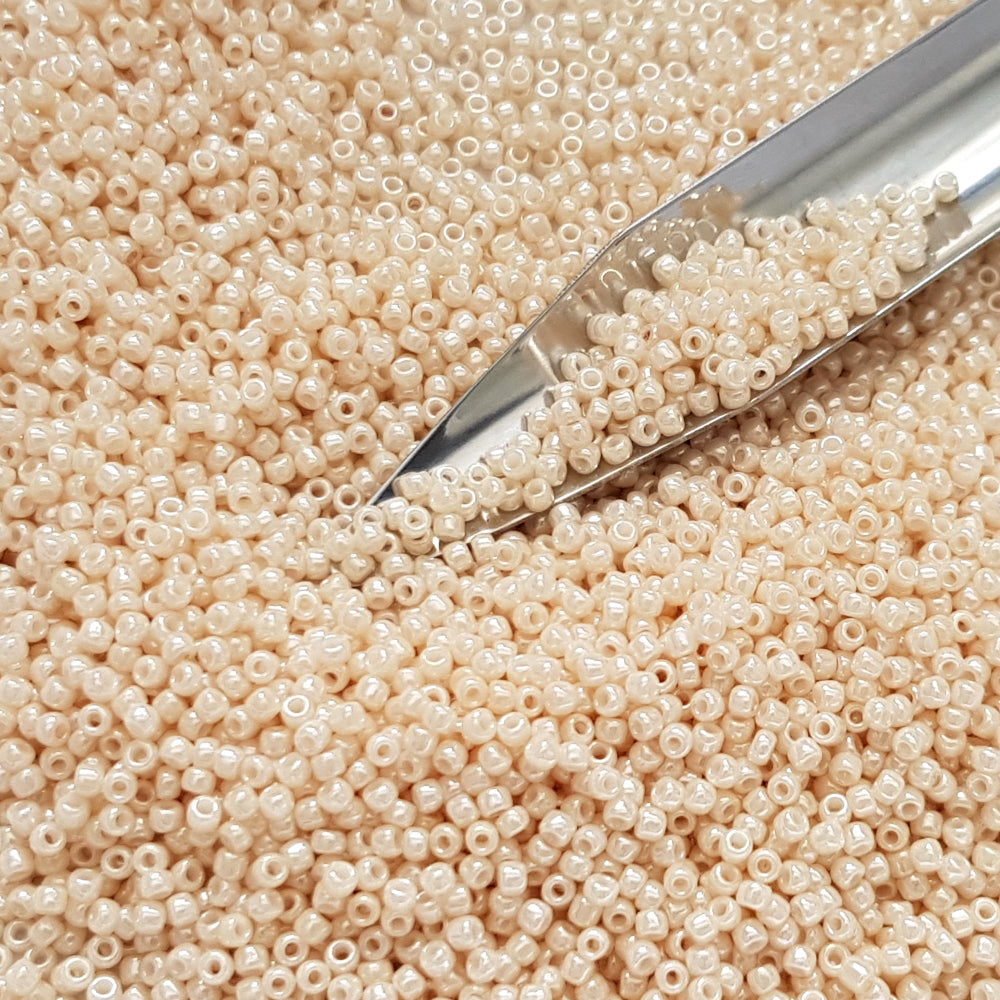 15/0 Toho seed beads TR-123 close up beige with a beading scoop