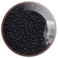 A clear plastic container filled with round jet black frosted opaque Toho seed beads, 15/0, 
