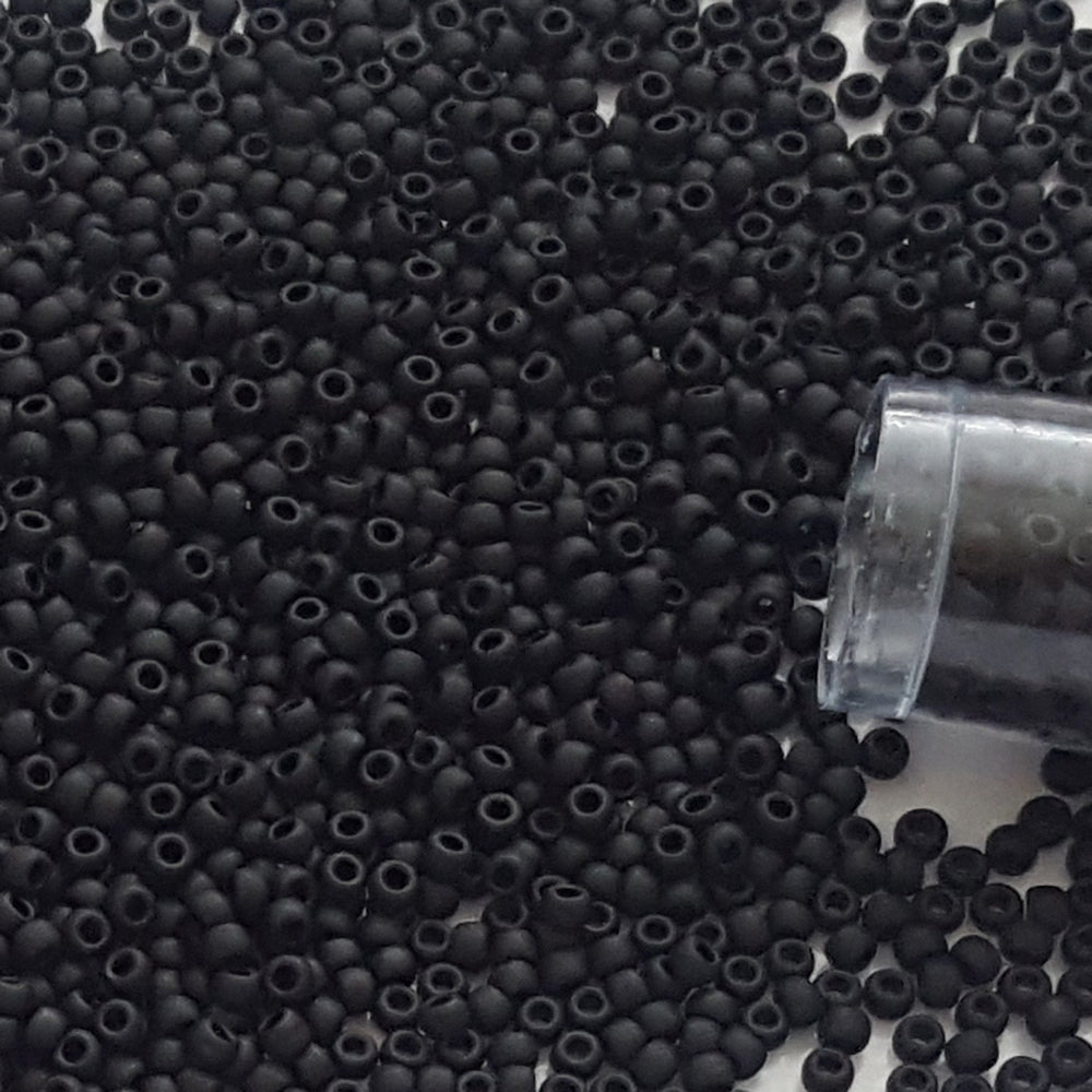 close up 15/0 jet black frosted opaque beads TR-49f with a tube end.