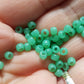close up on hand jade green beads