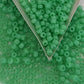 close up jade green beads with a triangle scoop.
