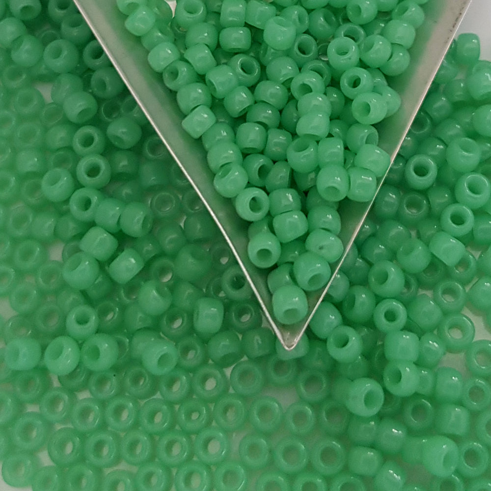 close up jade green beads with a triangle scoop.