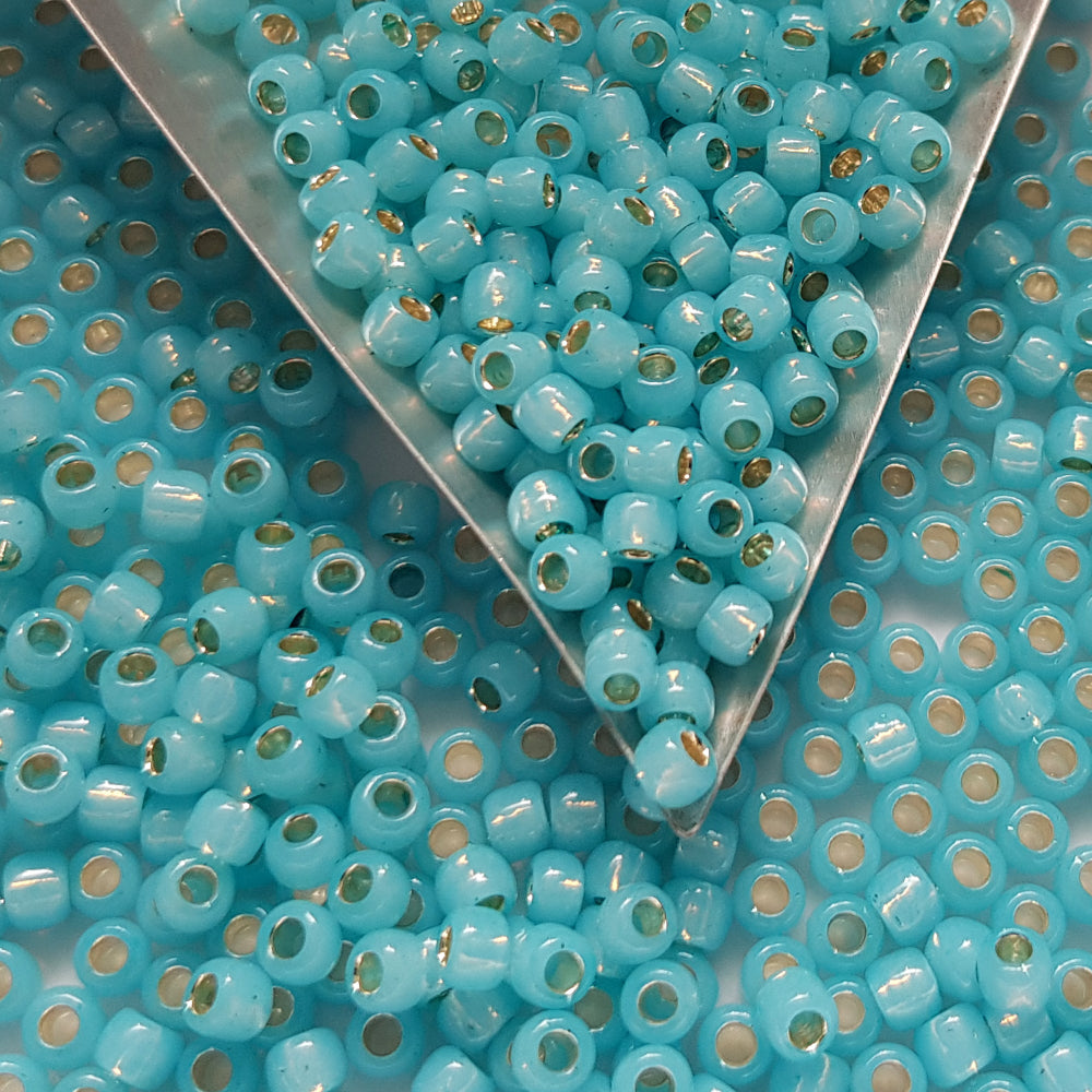 close up milky aqua beads with a triangle scoop