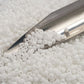 close up white frosted beads with a beading scoop
