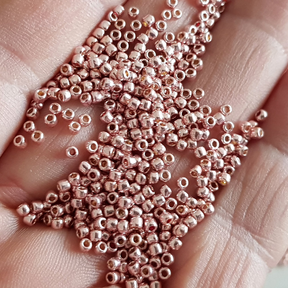Rose gold beads on a hand