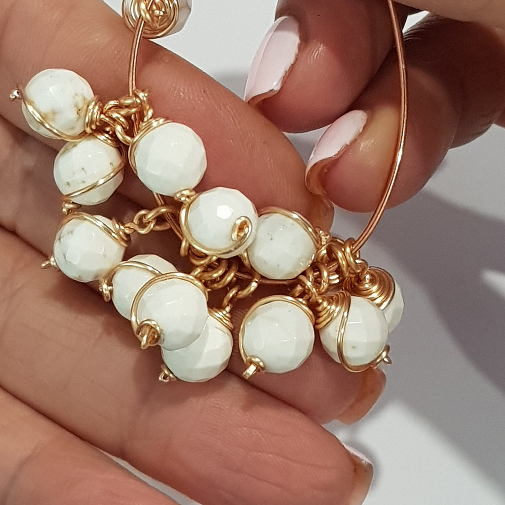 Single handmade 8 mm white howlite bead dangle showing gold-coloured wire wrap and open jump ring, SKU DBD-WP-WH-1pair