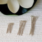 Eye Pins different lengths on a white background with a flower on the top.