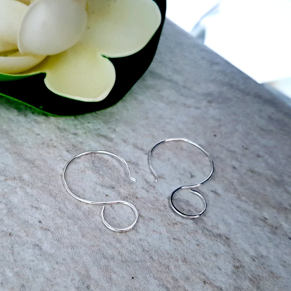 Premium Quality Earring Hooks, Large Hanging Loops for Resin Designs on marble with a flower top corner .