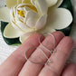 A pair of kidney hooks on a hand, flower background