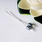 Argentium Long 60mm 2pcs Headpins Balled Flat with a bead on each, sample, white background flower top corner.